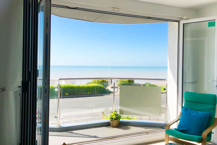Open balcony doors with sea view
